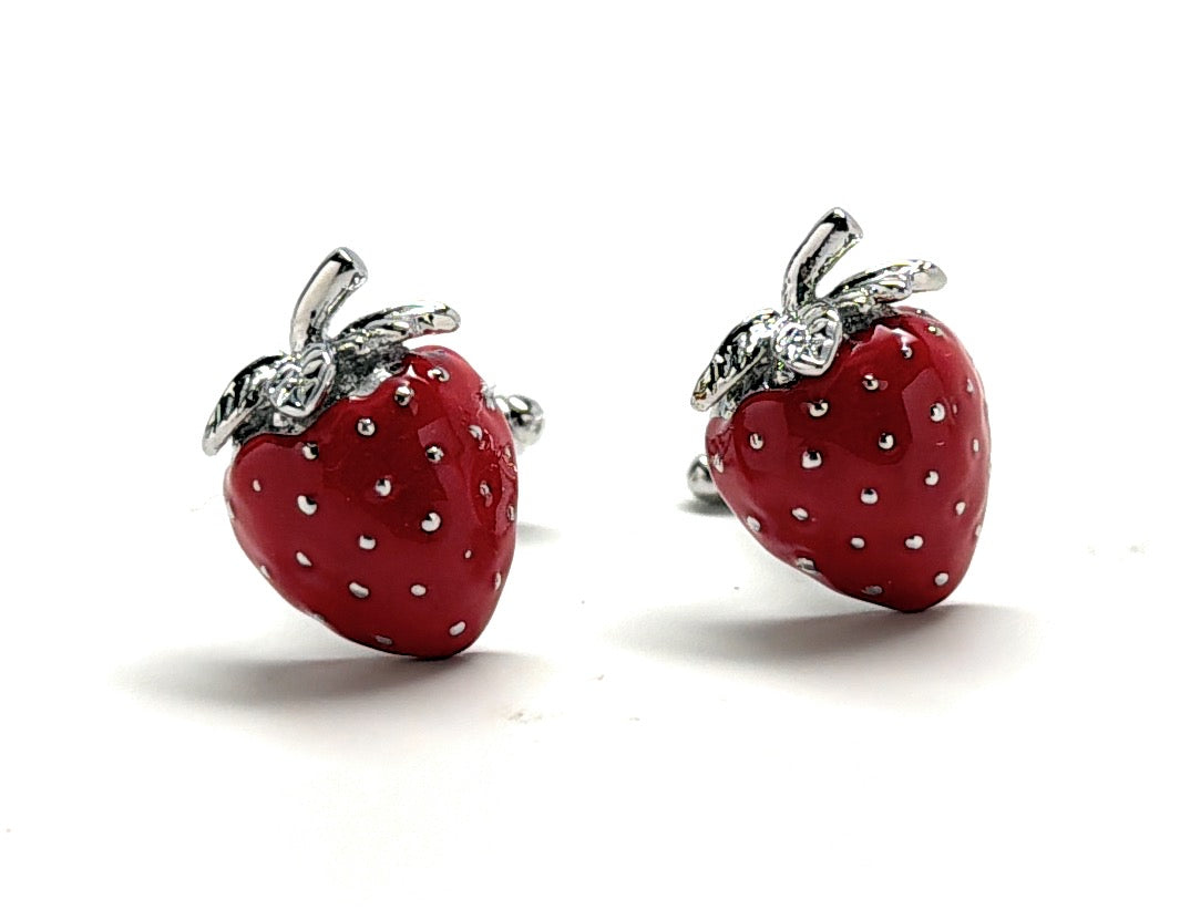 A pair of glossy red strawberry cufflinks with silver leaves by JayPins, symbolizing fresh, playful, and fun fashion accessories.