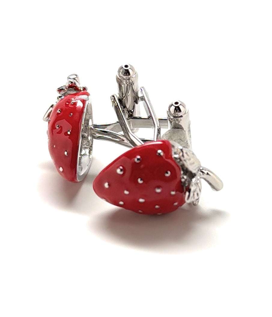 Red strawberry-shaped cufflinks with silver accents on a white background
