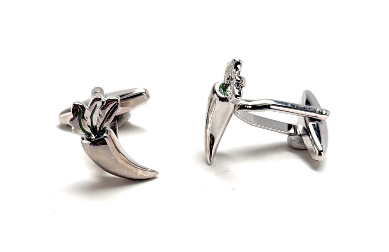 Silver cufflinks with a unique design on a white background