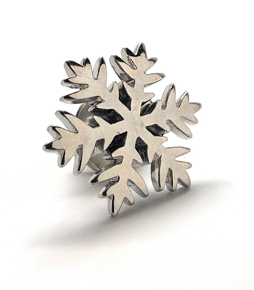 Silver snowflake-shaped object on a white background