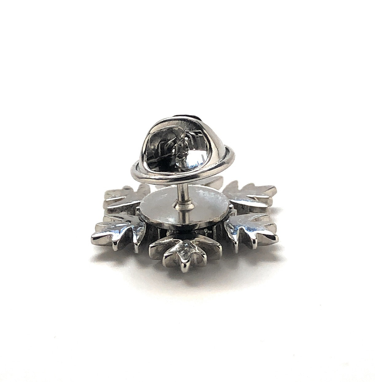 Silver earring with a clear gemstone on a white background