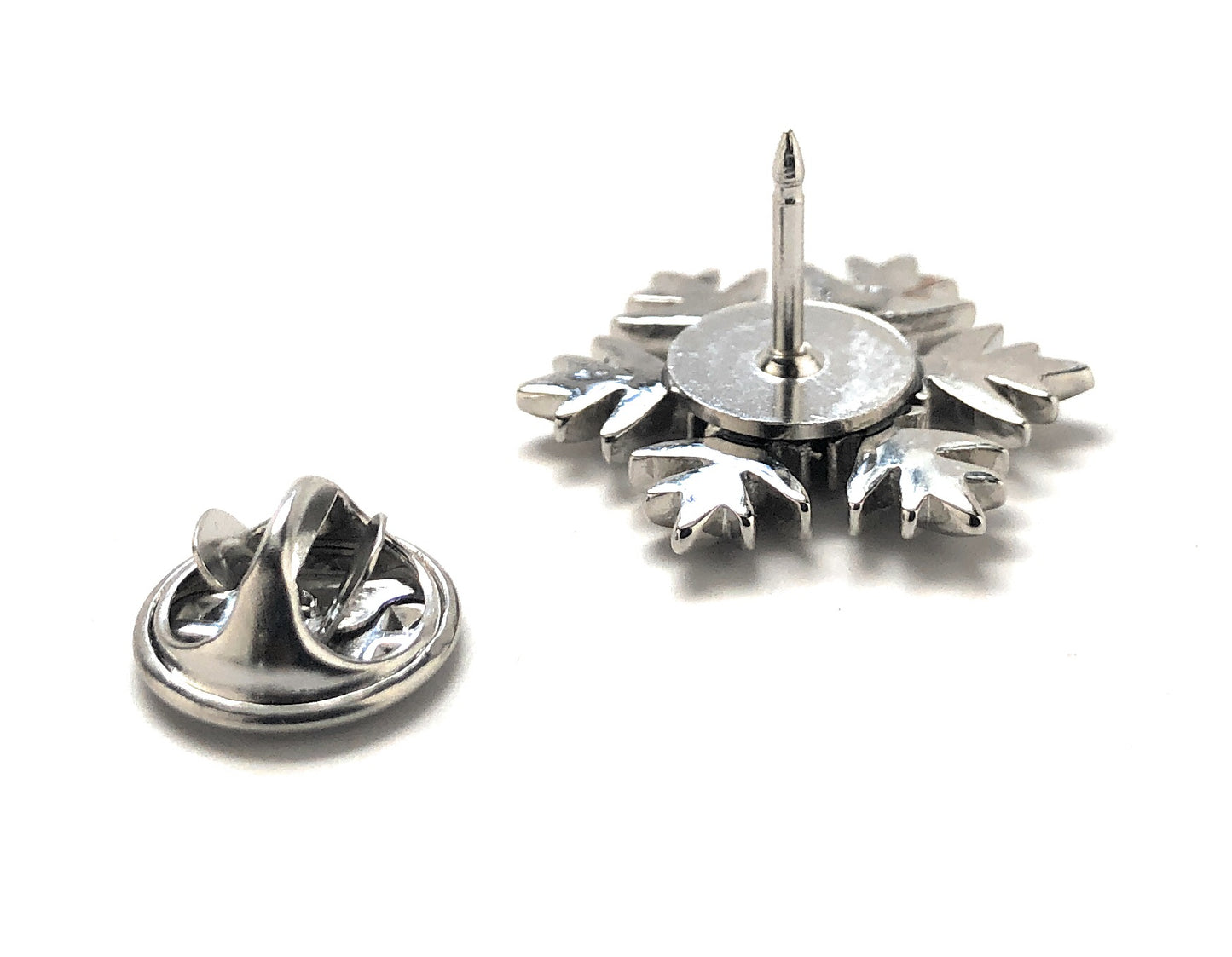 Metallic badge with a star-shaped design on a white background