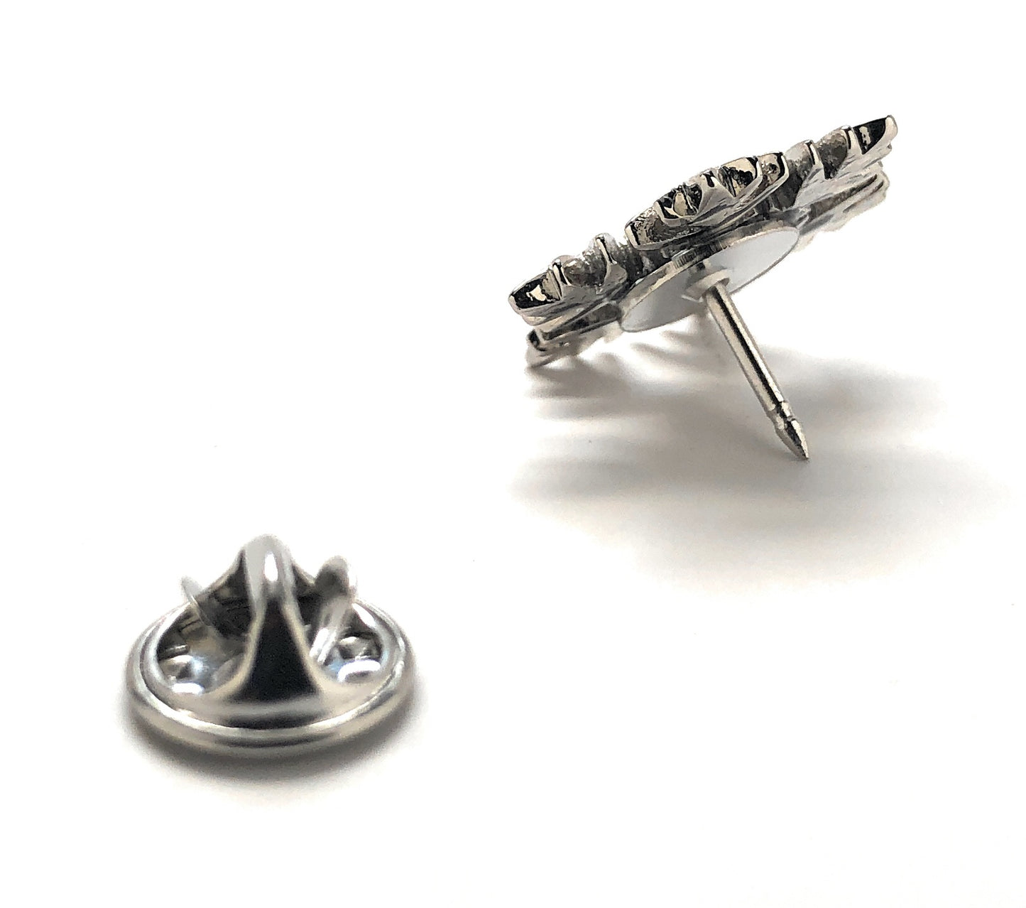 Pair of silver earring studs on a white background