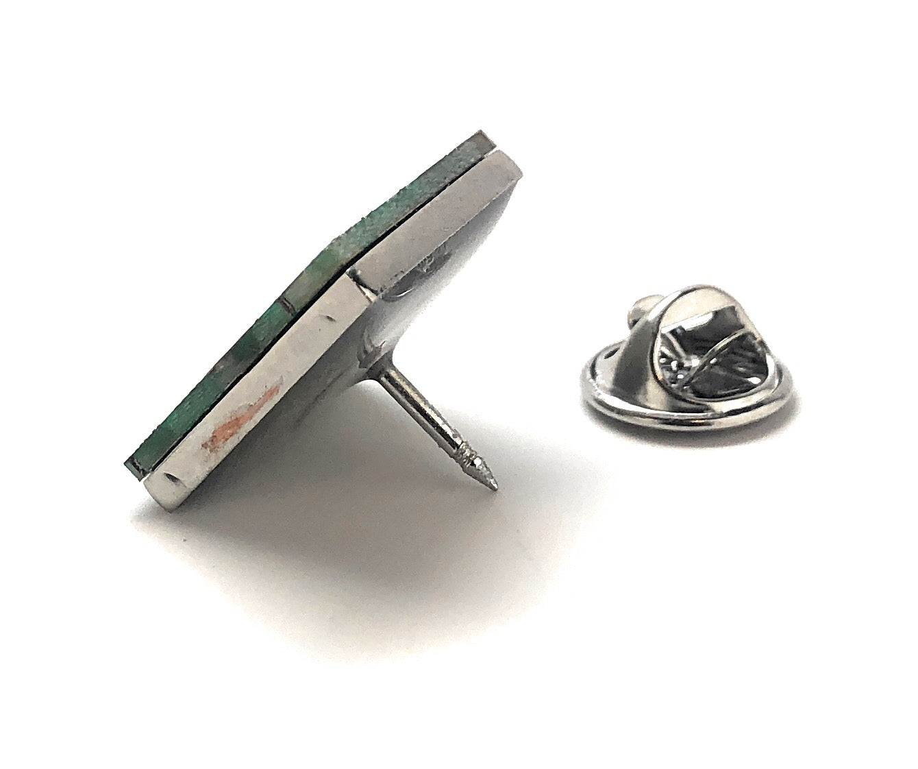 Silver earring with a green stone on a white background