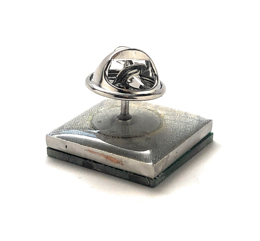 Silver ring on a metallic stand against a white background