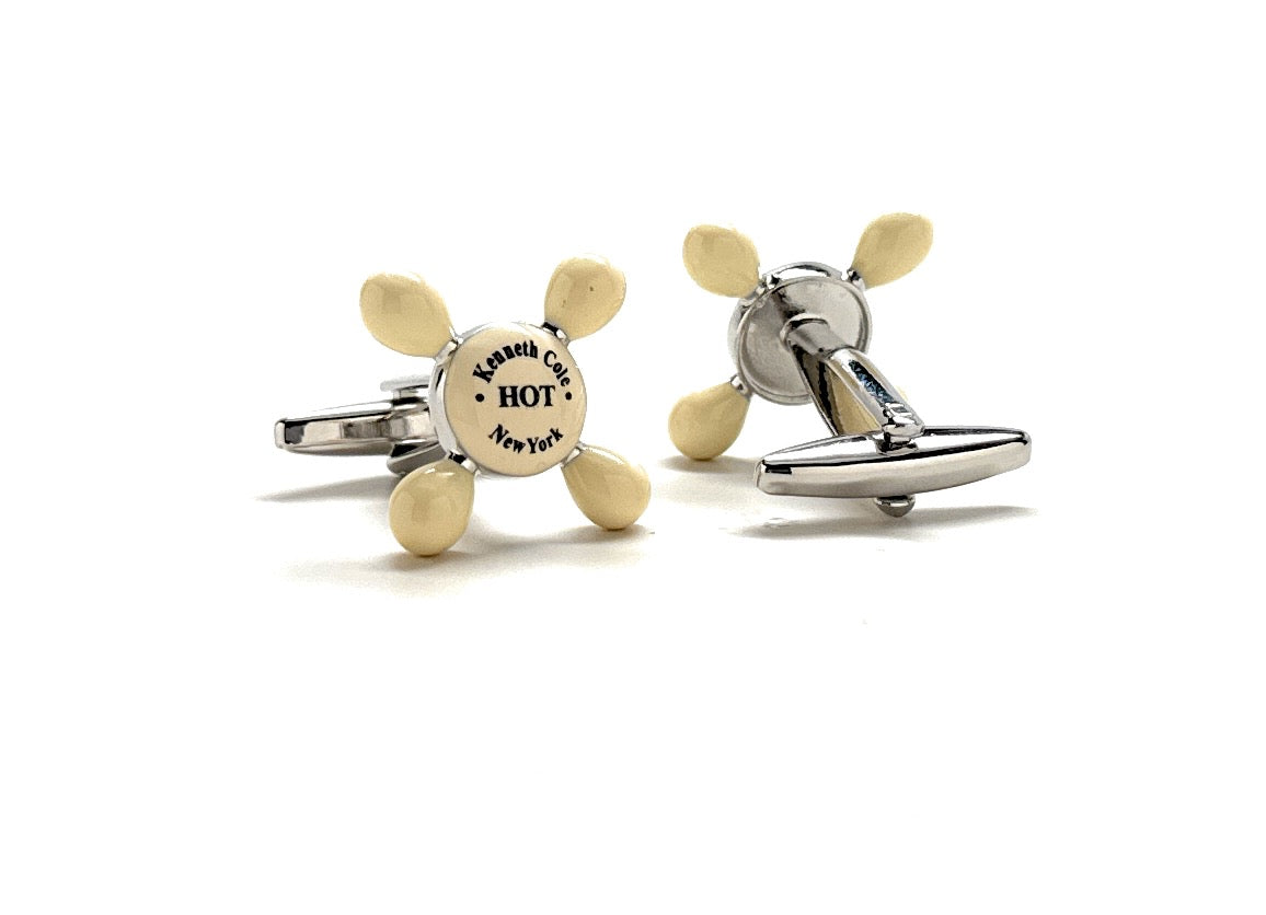 Propeller-shaped cufflinks on a white background