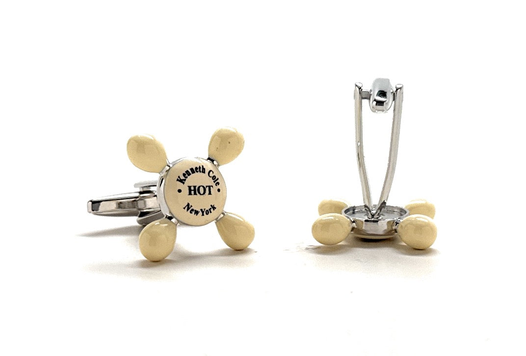 Gold and silver cufflinks with a circular design on a white background