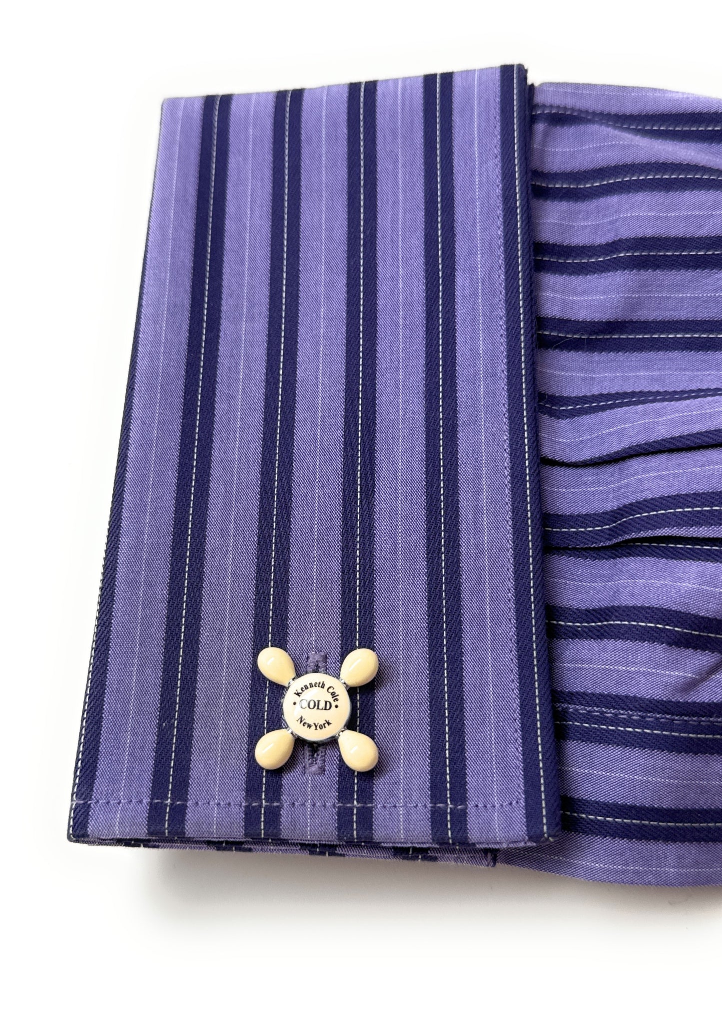 Purple striped fabric with a button on a white background