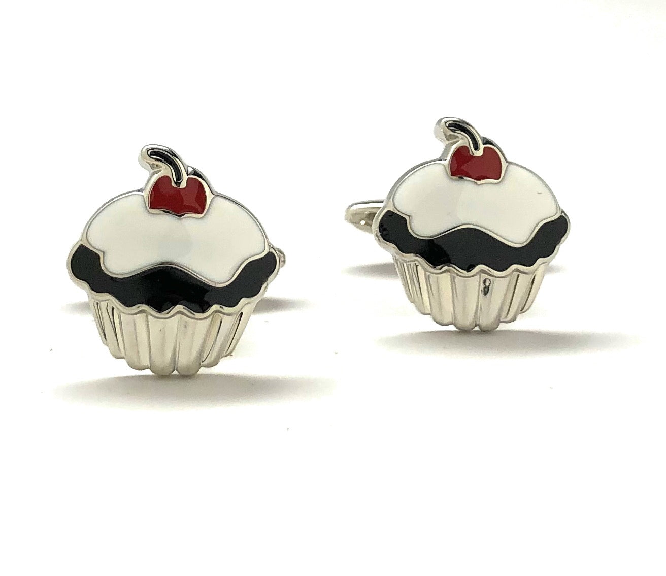Cupcake-shaped cufflinks with red hearts on a white background