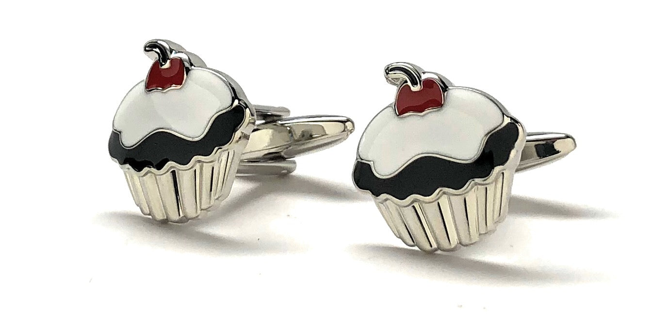 Cupcake-shaped cufflinks with red berries on a white background