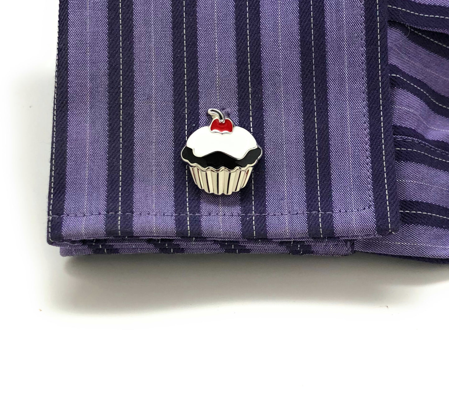 Cupcake-shaped pin on a striped shirt