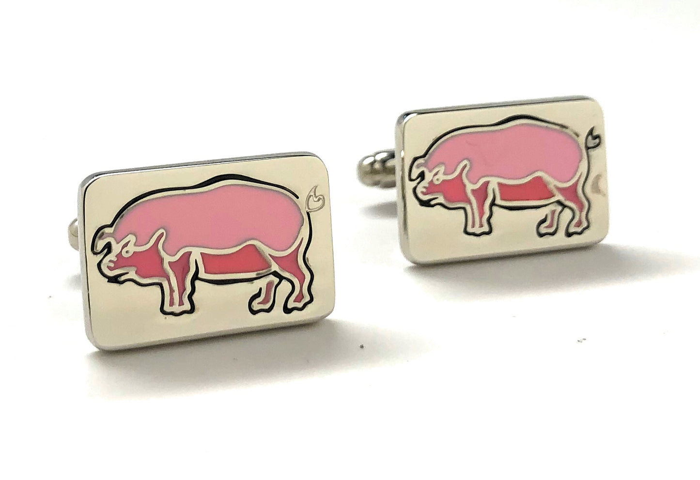 Cufflinks with pink pig design on a white background