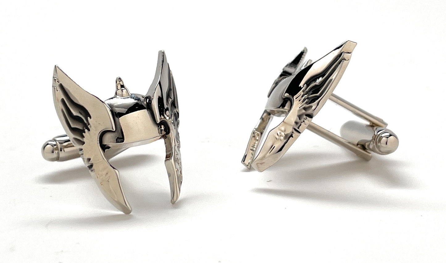 Pair of silver arrowhead-shaped cufflinks on a white background