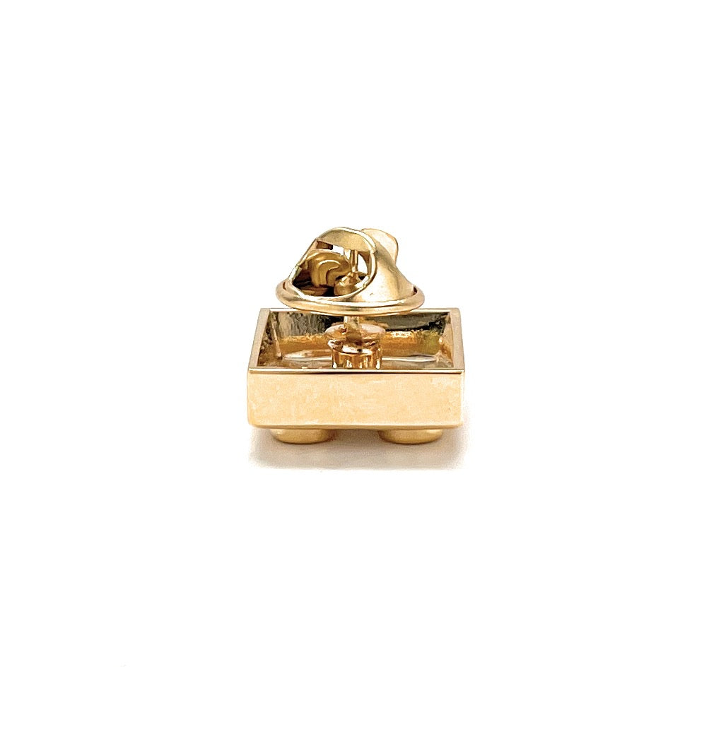 Gold pendant on a white background