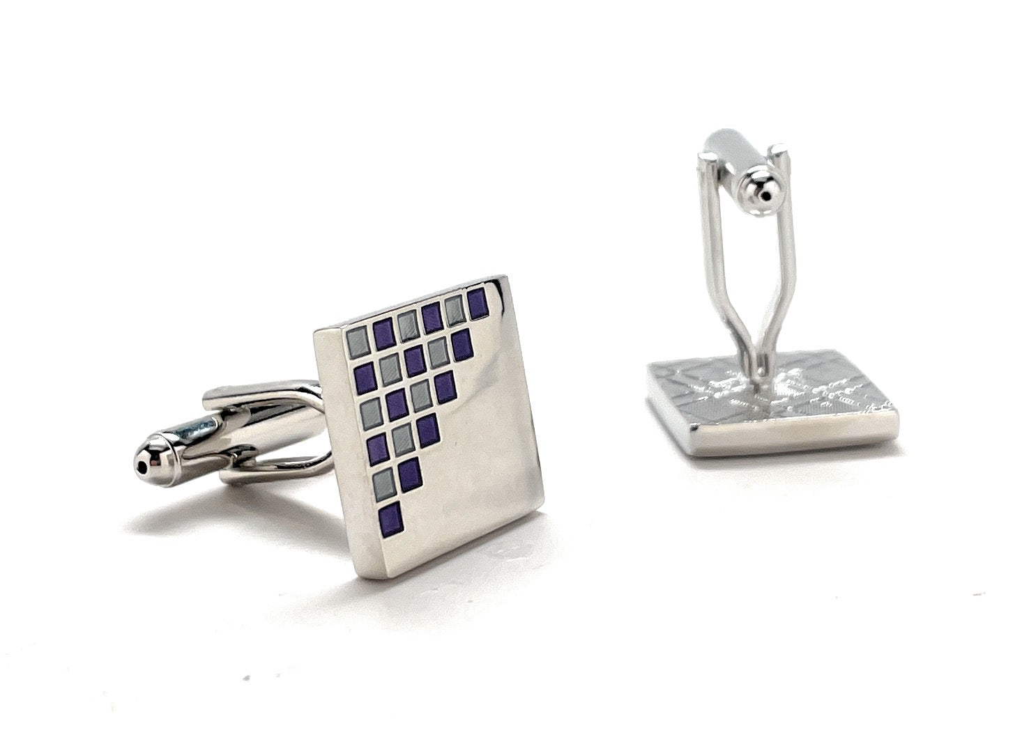 Square cufflinks with a geometric pattern on a white background
