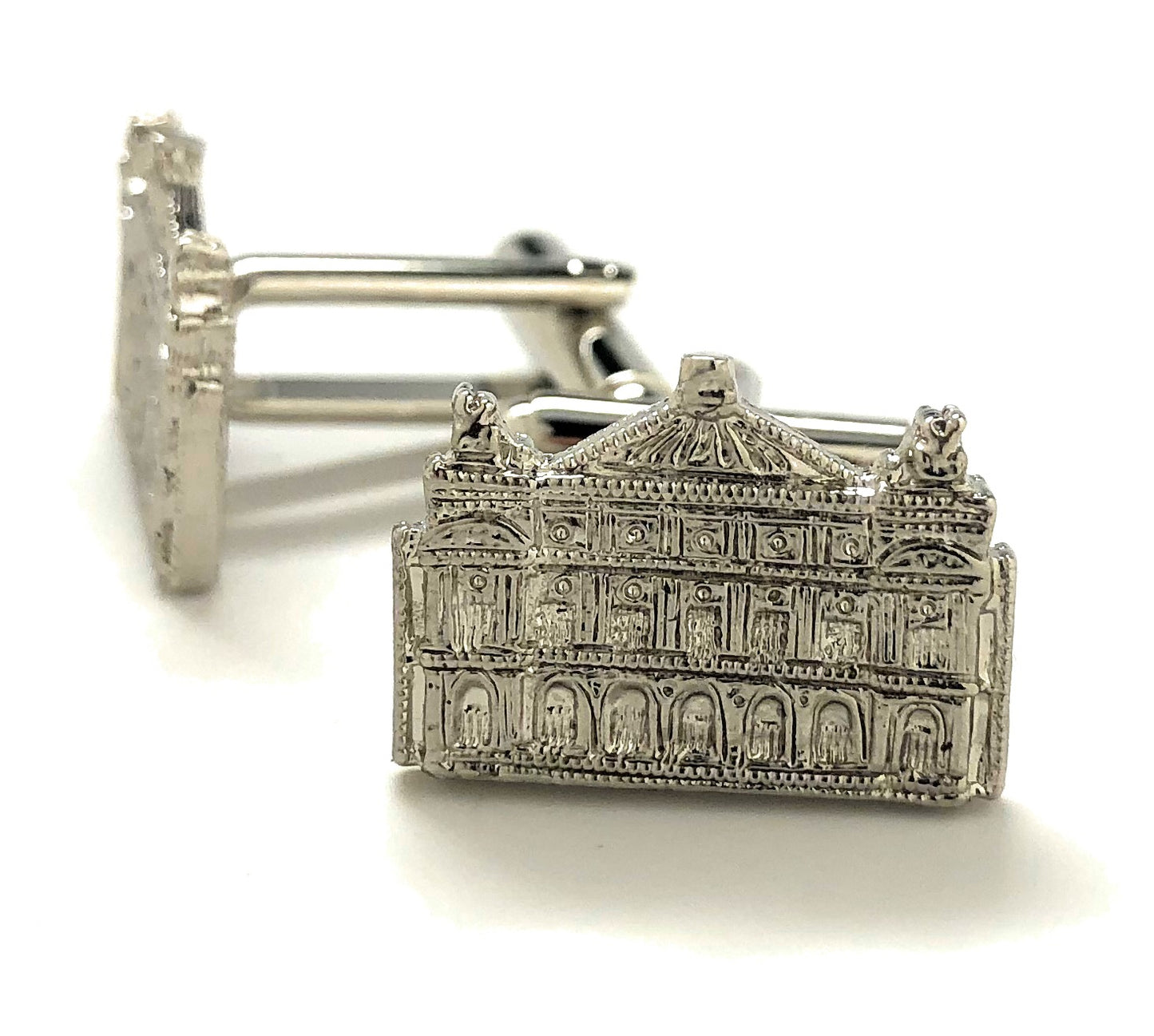 Silver architectural cufflinks on a white background