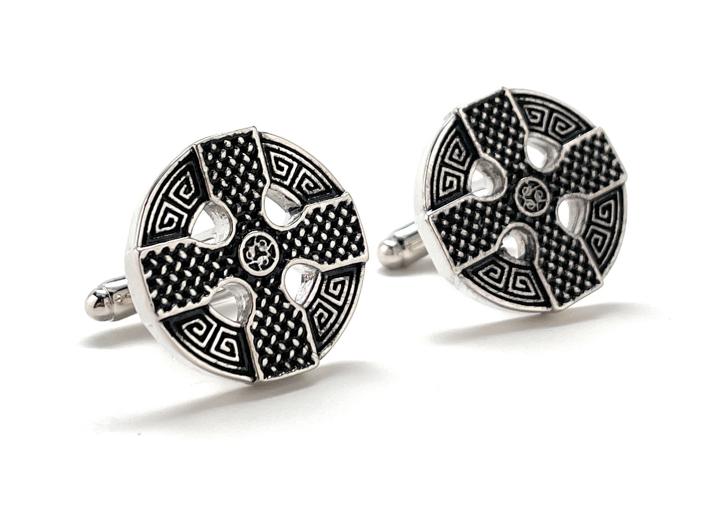 Pair of black and silver patterned cufflinks on a white background