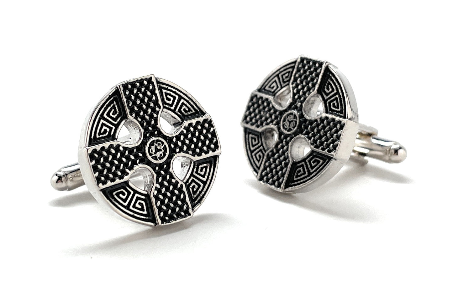 Pair of silver and black patterned cufflinks on a white background