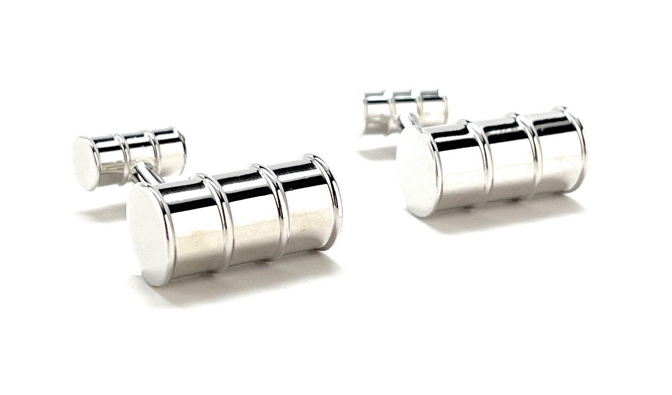 Pair of silver cylindrical cufflinks on a white background