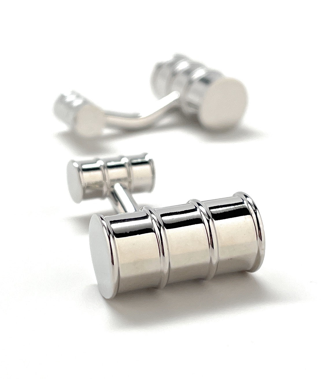 Silver cufflinks on a white background