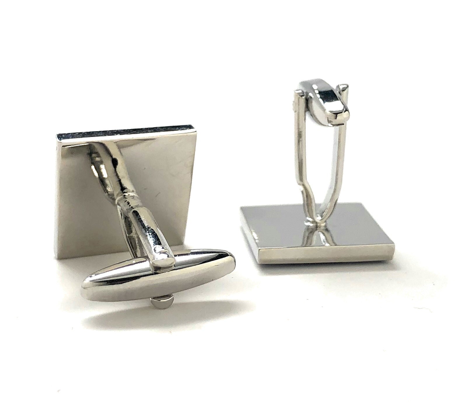 Silver cufflinks on a white background