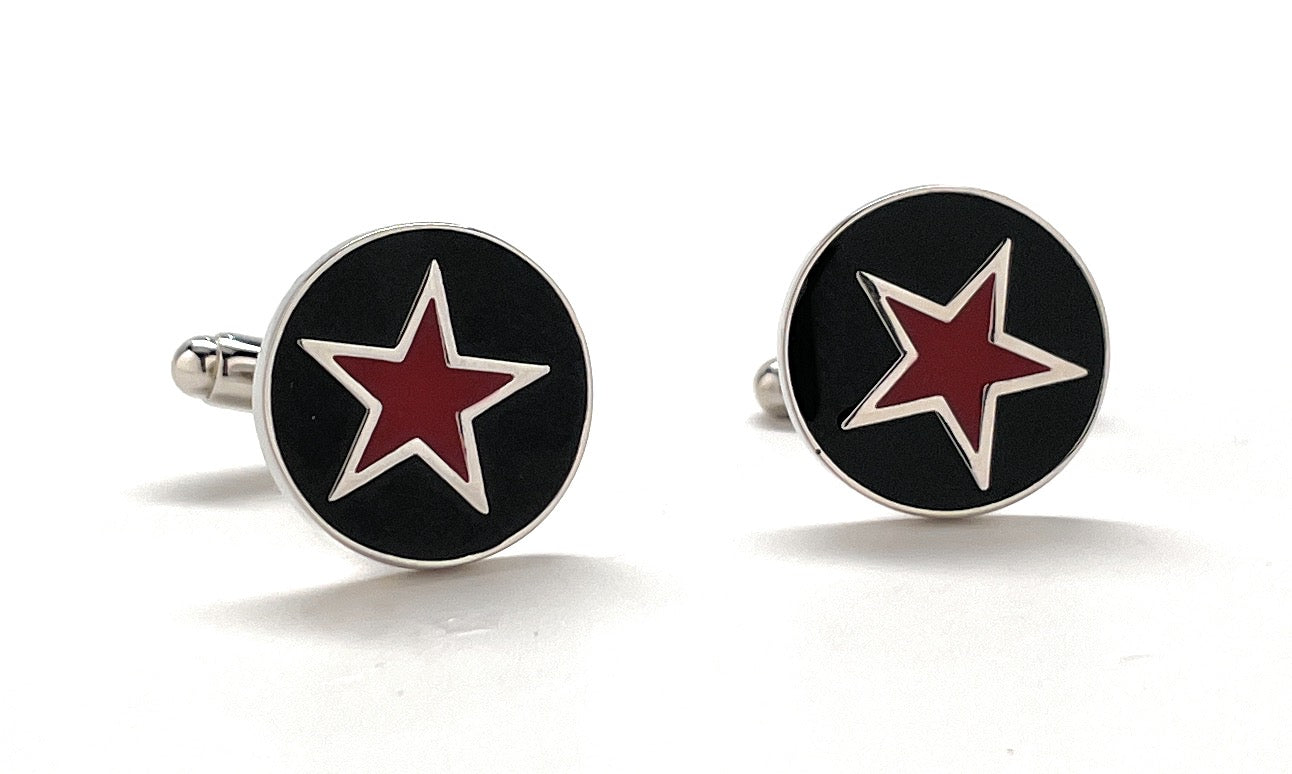 Pair of round cufflinks with red star design on black background