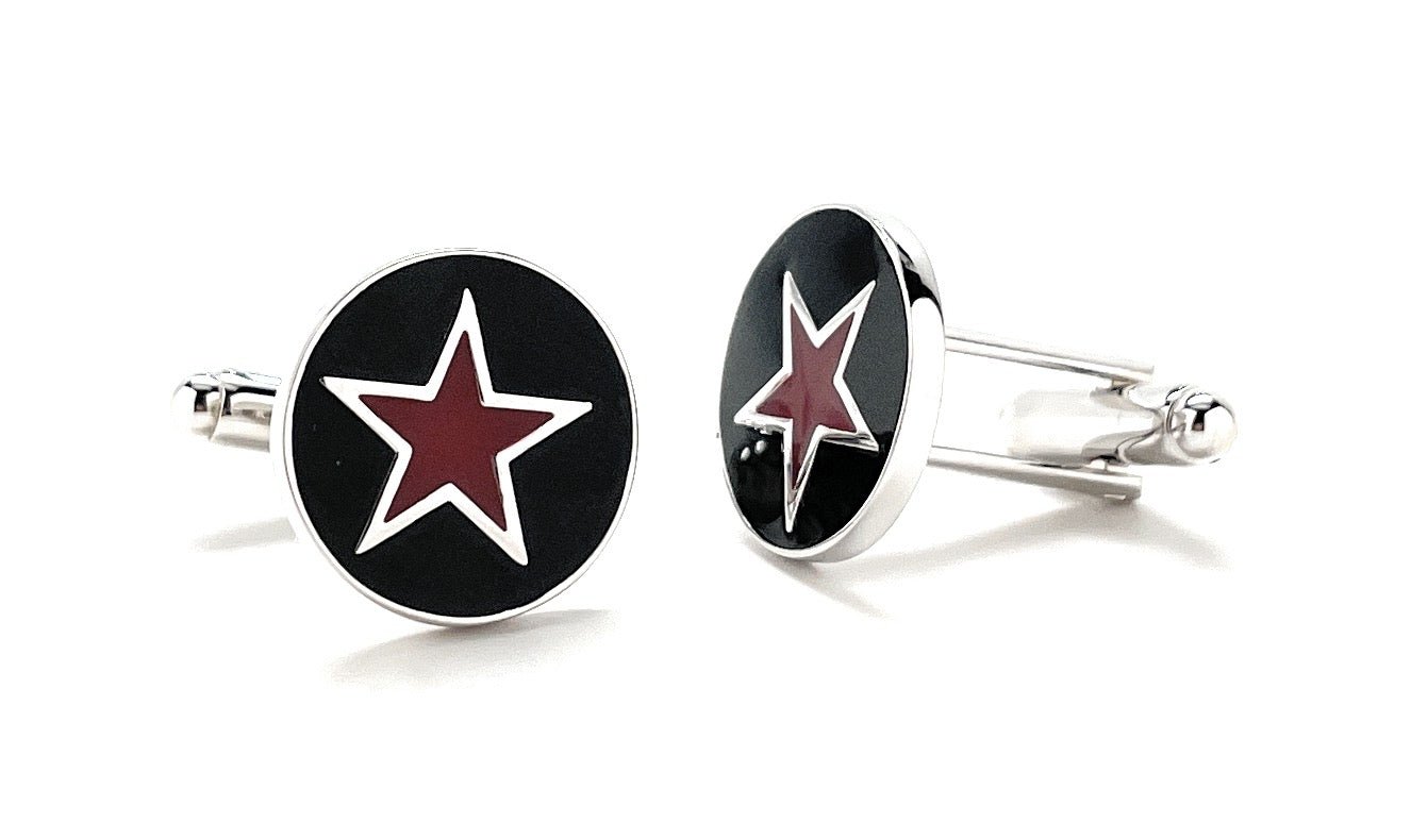 Pair of cufflinks with red star design on black background