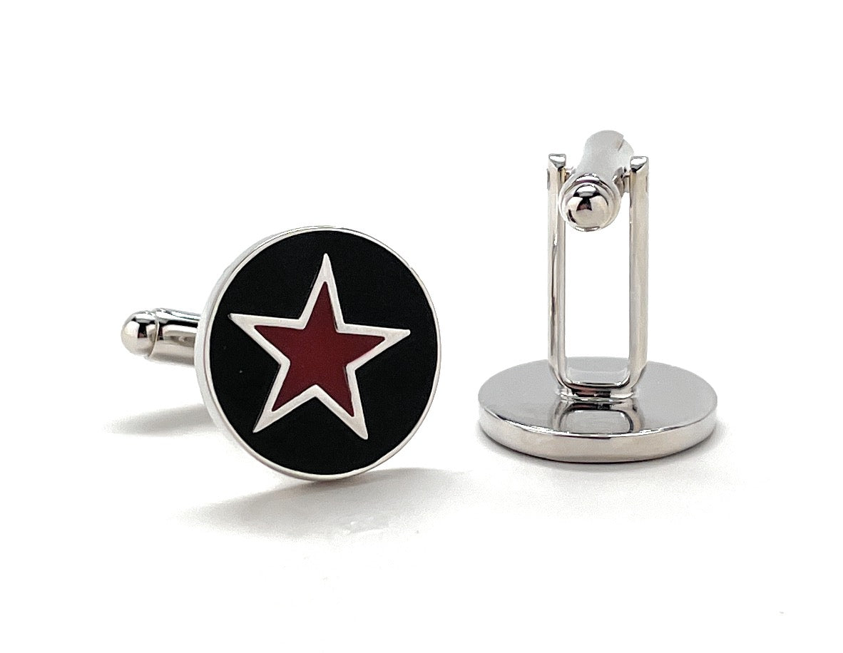 Cufflinks with a red star design on a black background