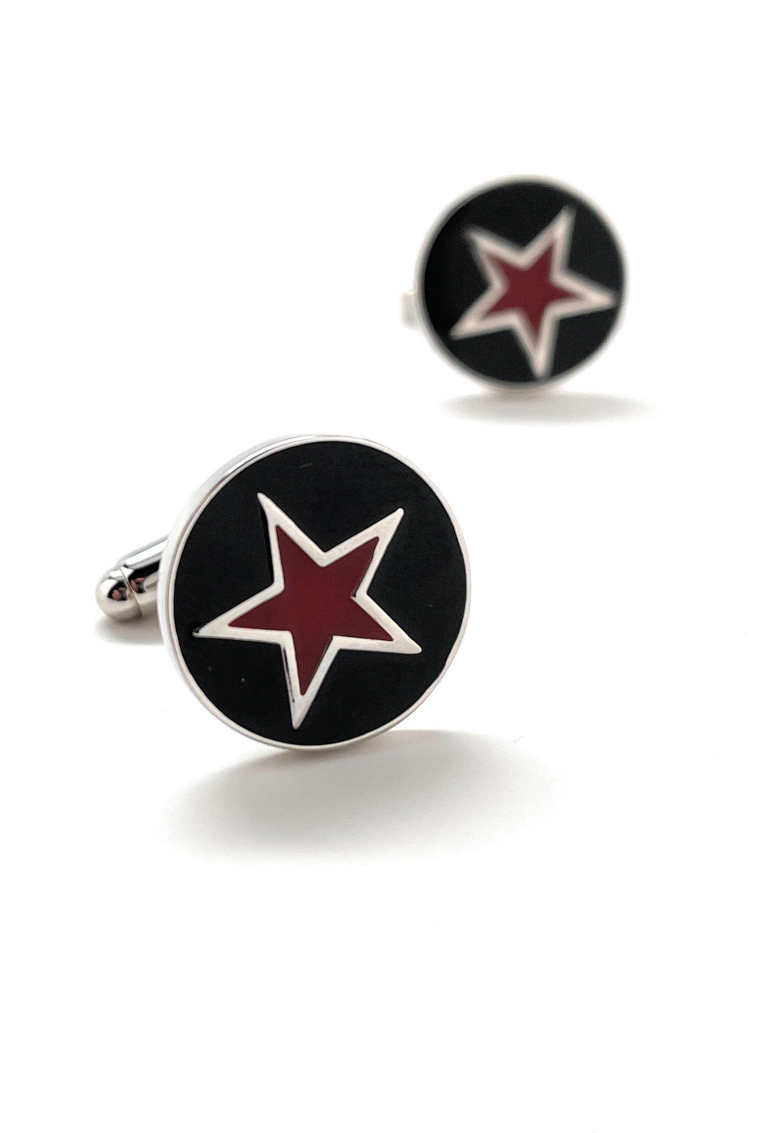 Cufflinks with red star design on black background