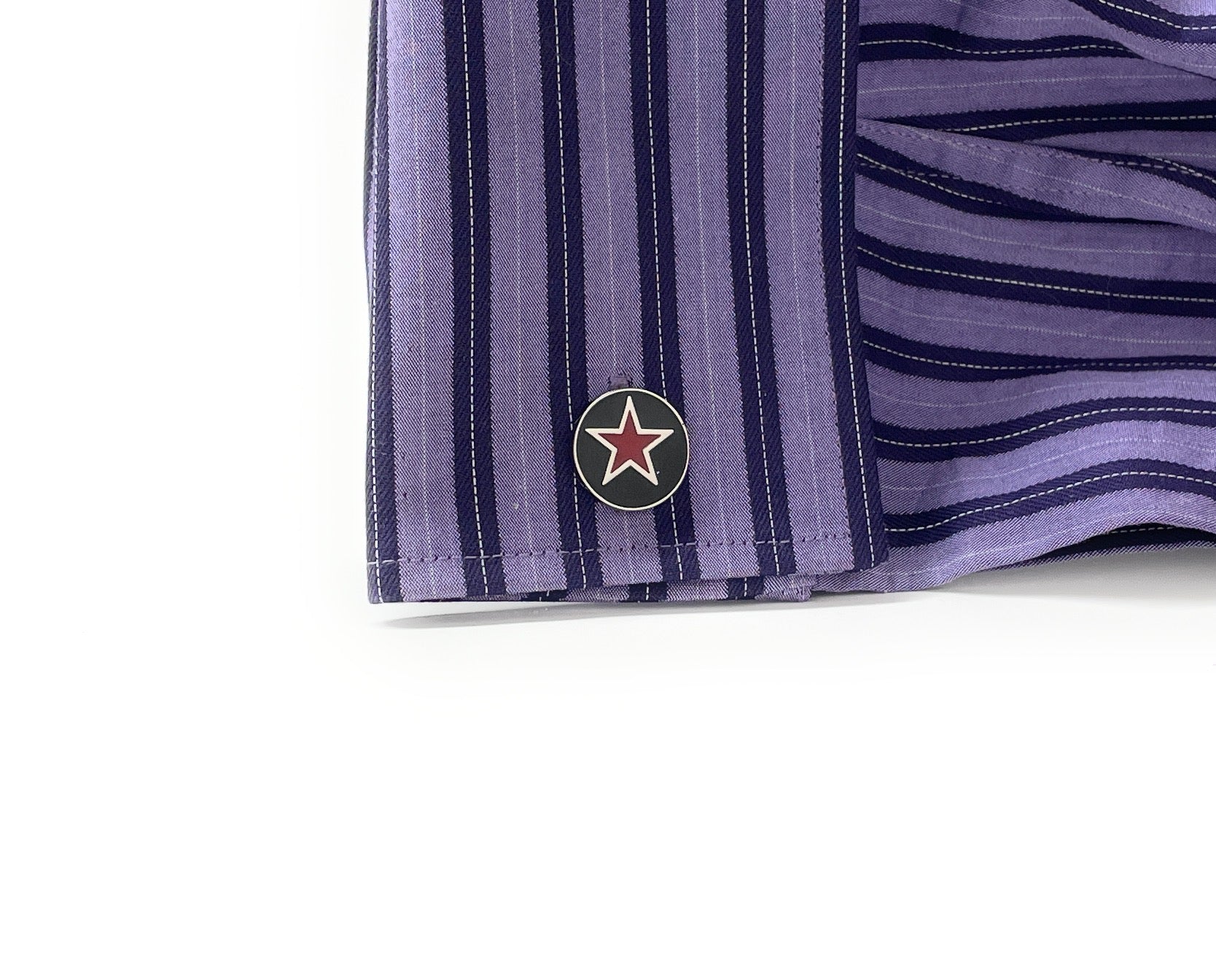 Close-up of a purple striped shirt with a logo on a white background