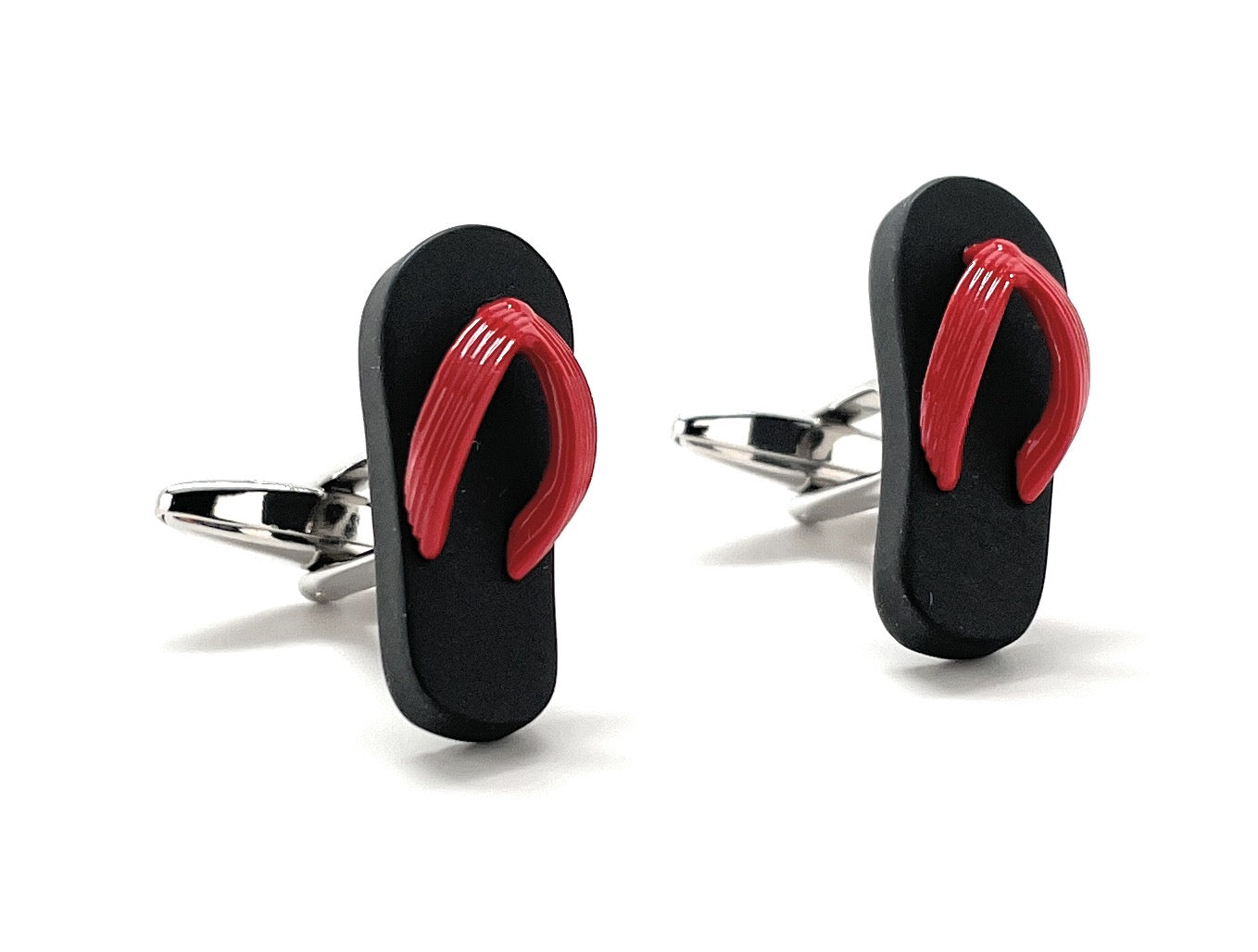 Flip-flop cufflinks with red straps on a white background