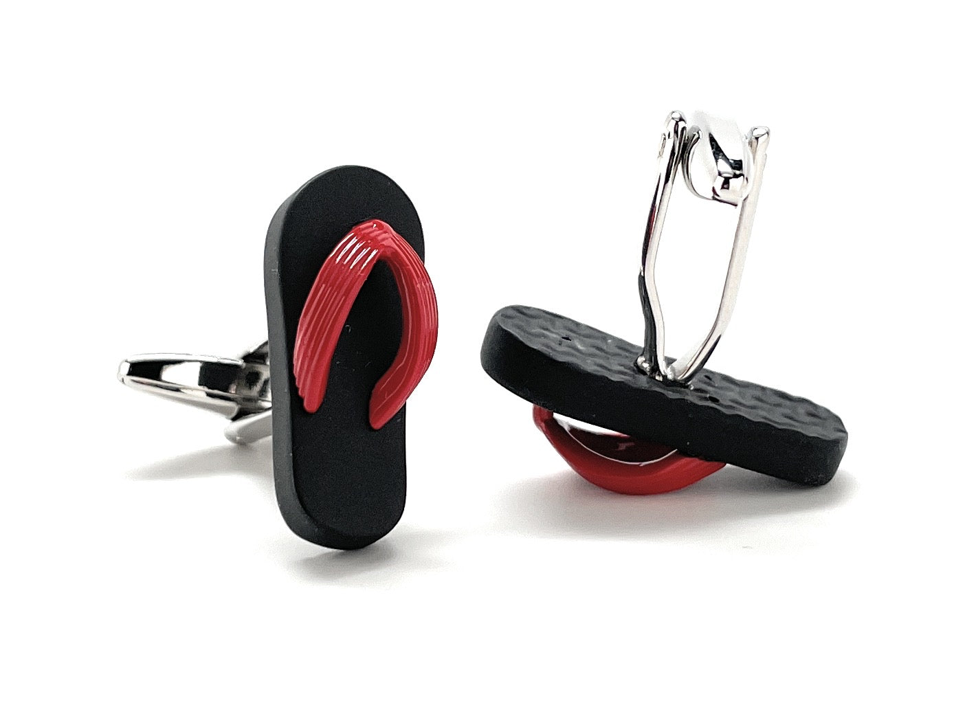 Flip-flop cufflinks with red soles and black straps on a white background