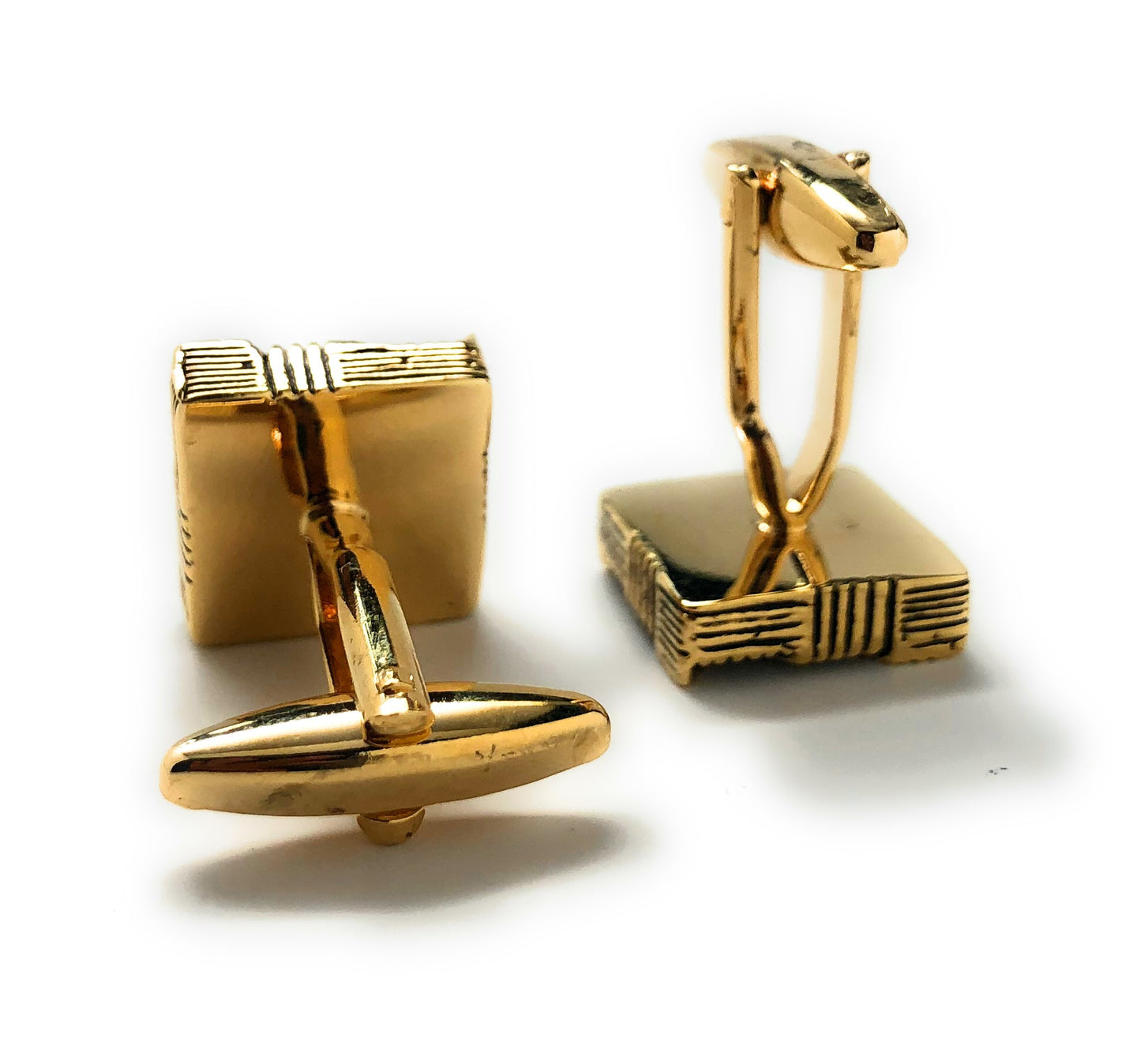 Gold cufflinks on a white background