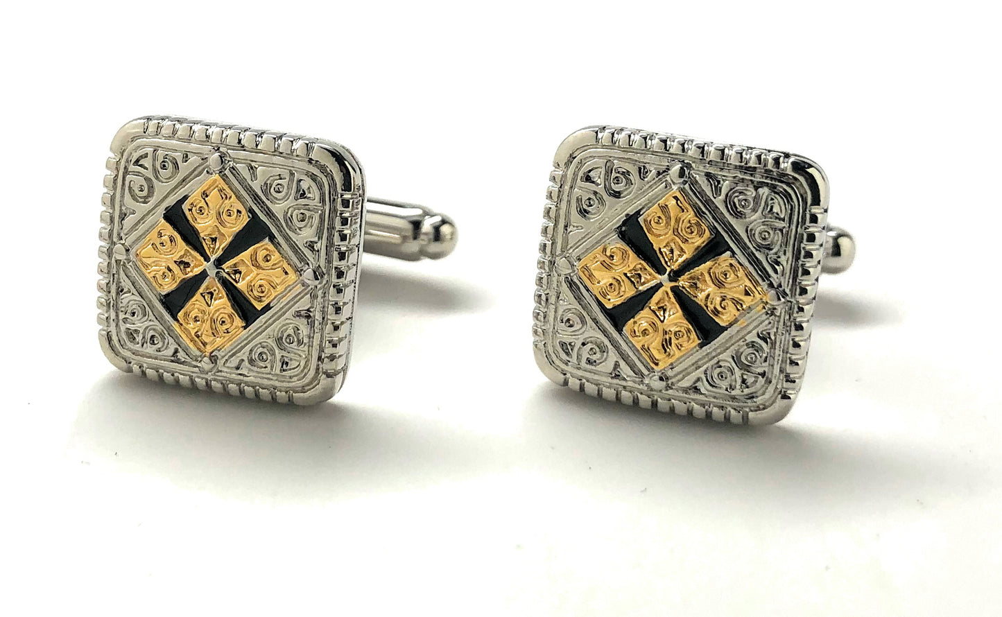 Pair of square cufflinks with gold and black design on a white background