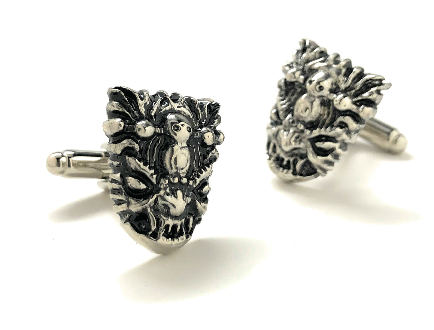 Pair of silver yeti head cufflinks on a white background