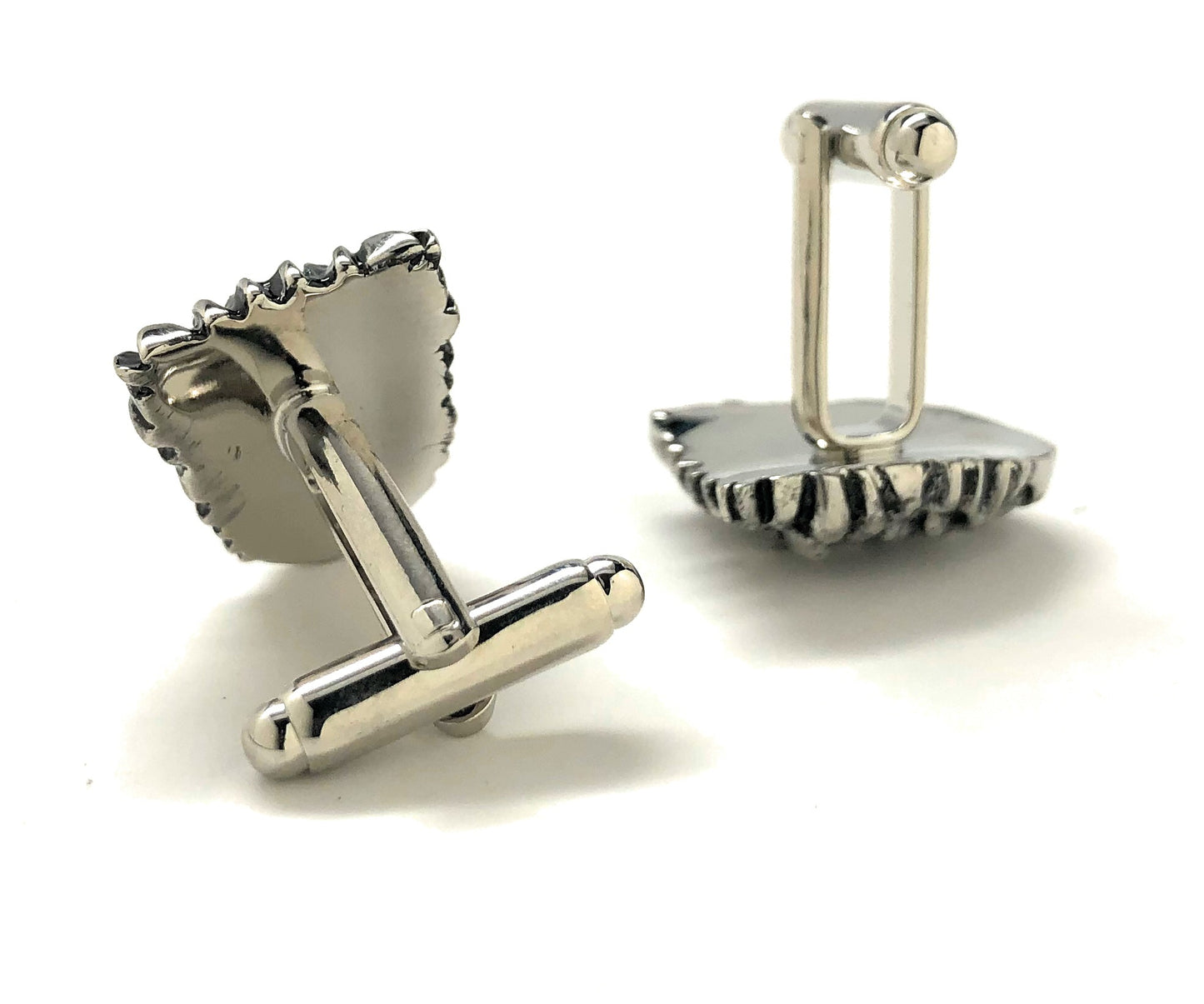 Silver cufflinks on a white background