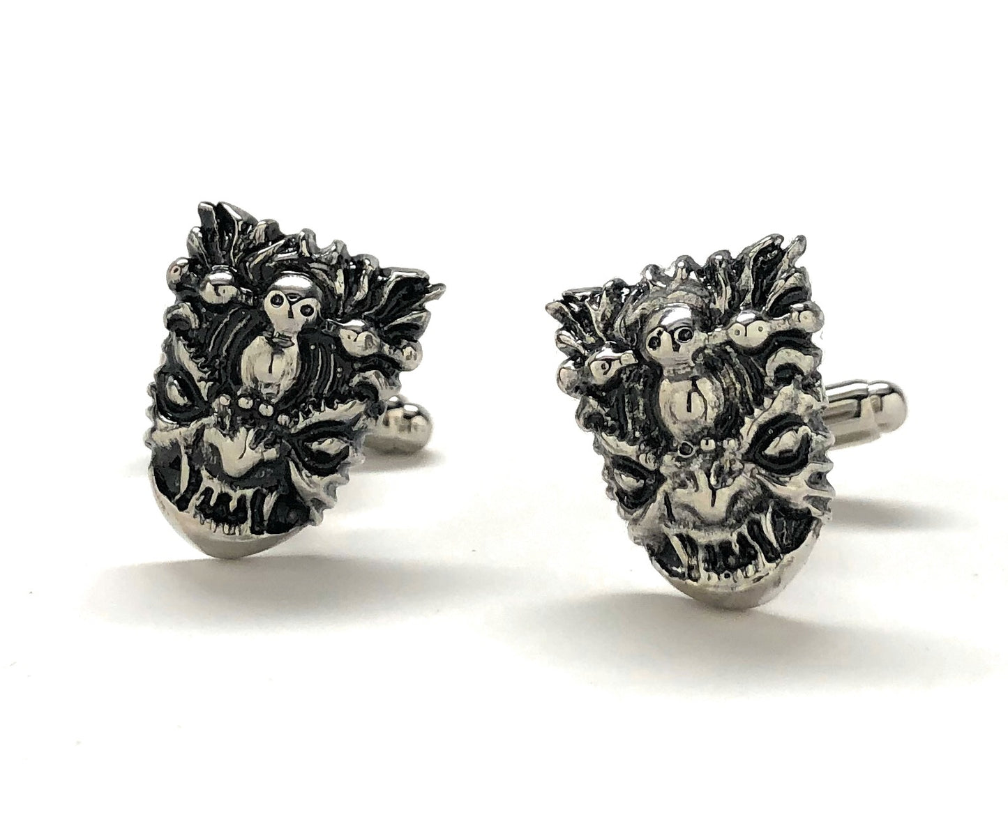 Pair of silver yeti head cufflinks on a white background