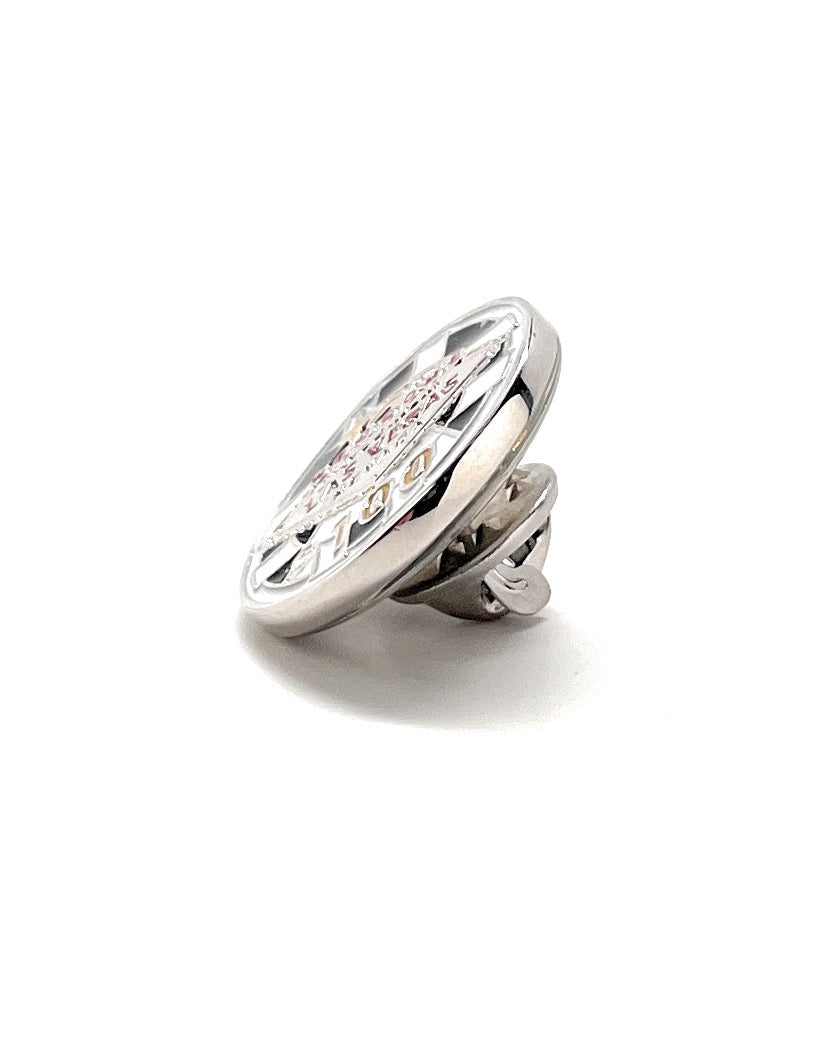 Silver brooch with clear gemstones on a white background