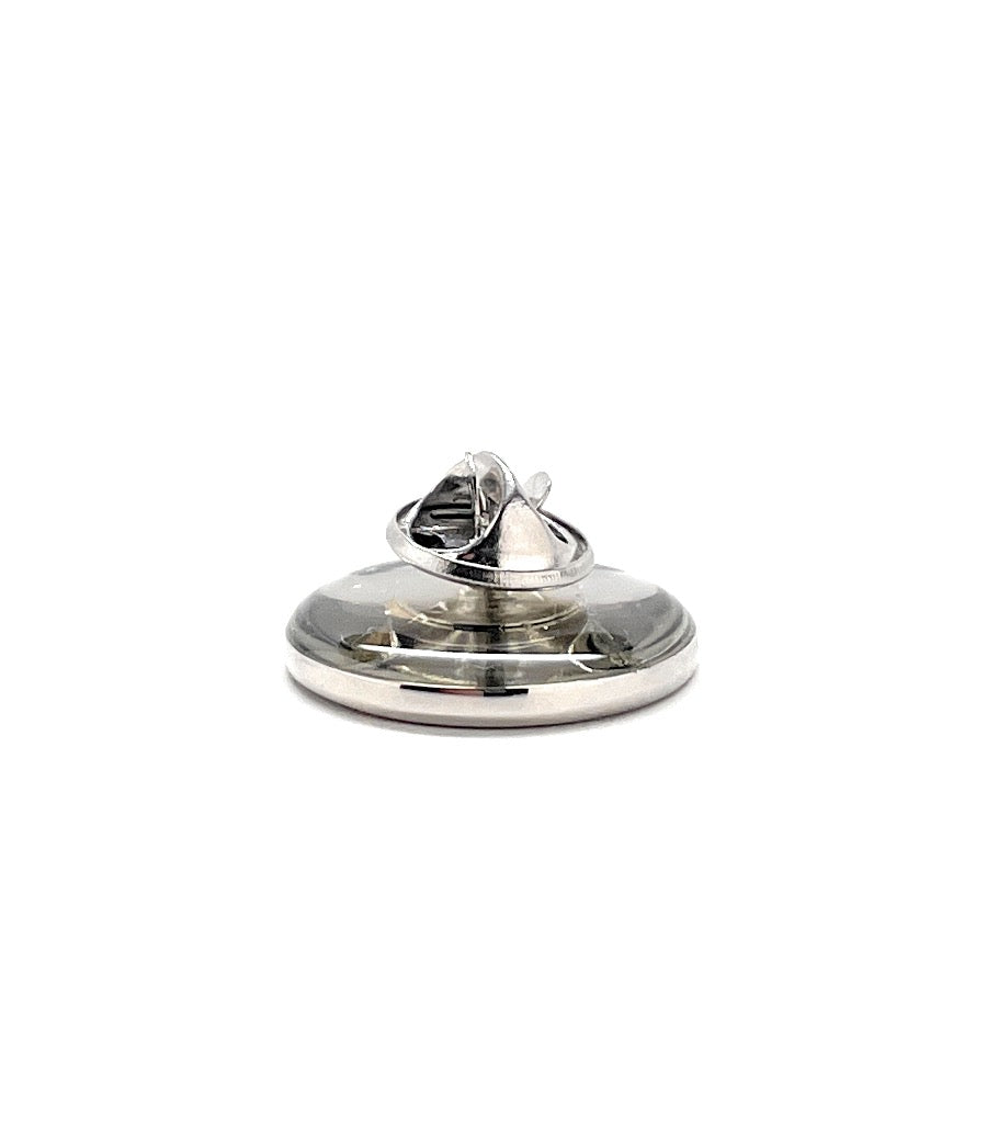 Silver ring with a clear stone on a white background