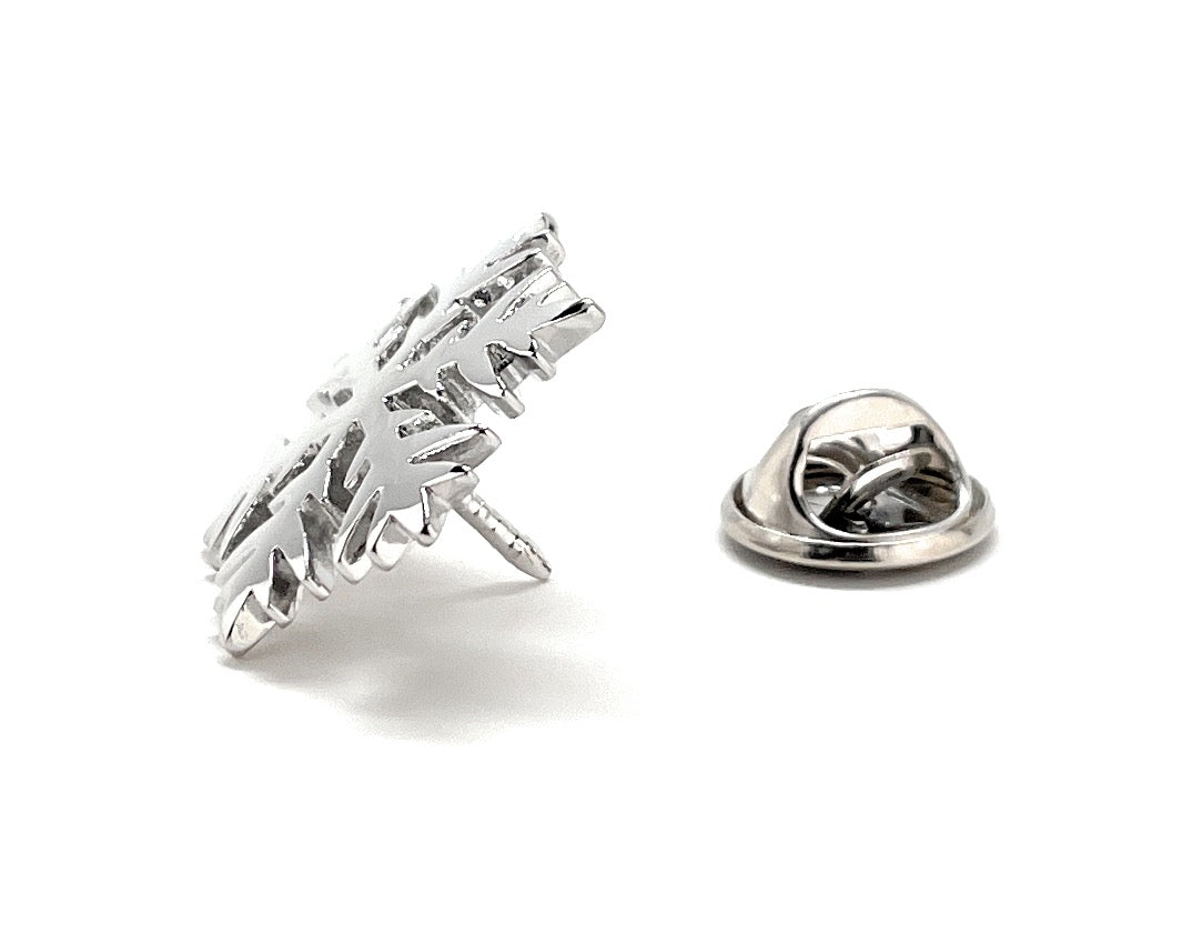 Silver metal badge with a detailed design on a white background