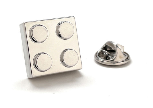 Metallic square pin with circular designs on a white background