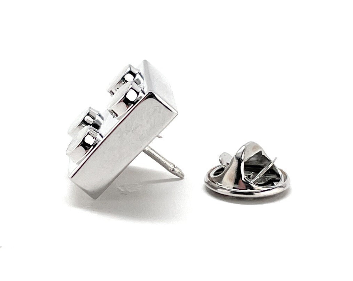 Metallic badge or lapel pin on a white background