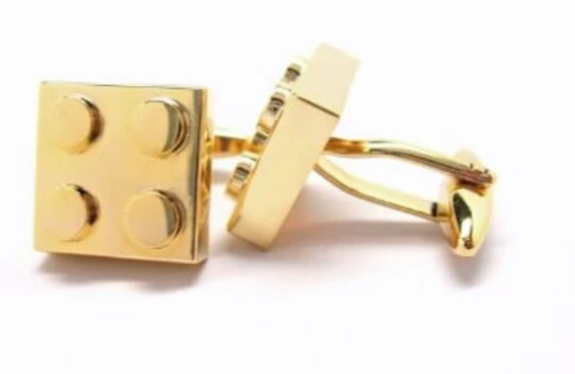 Gold square cufflinks on a white background