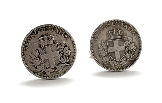 A pair of silver-colored cufflinks featuring inscriptions and national emblems, indicative of Italian origin.