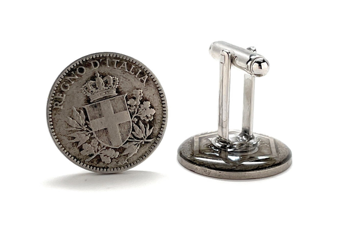 A pair of silver-colored cufflinks featuring inscriptions and national emblems, indicative of Italian origin.