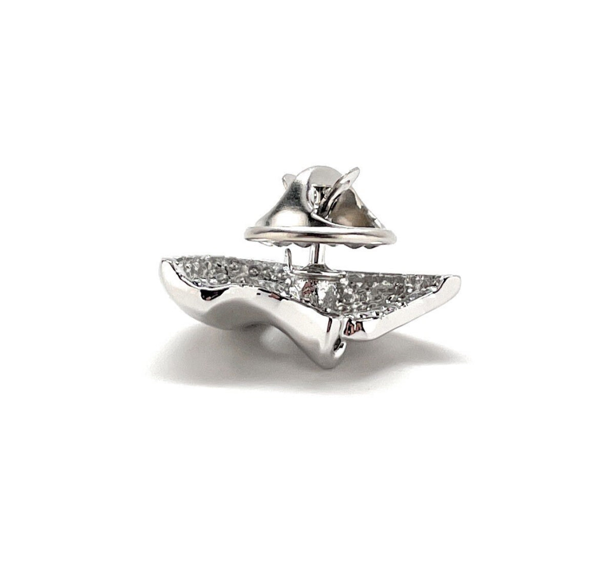 A silver-colored lapel pin in the shape of a mask, with a shiny finish and a butterfly back.
