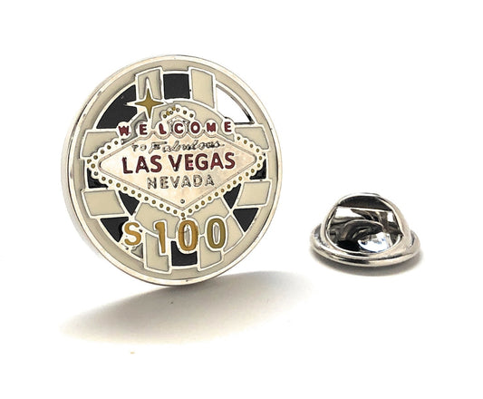 A silver-colored enamel pin shaped like a poker chip with '100' and 'LAS VEGAS NEVADA' text, along with a depiction of a casino scene.
