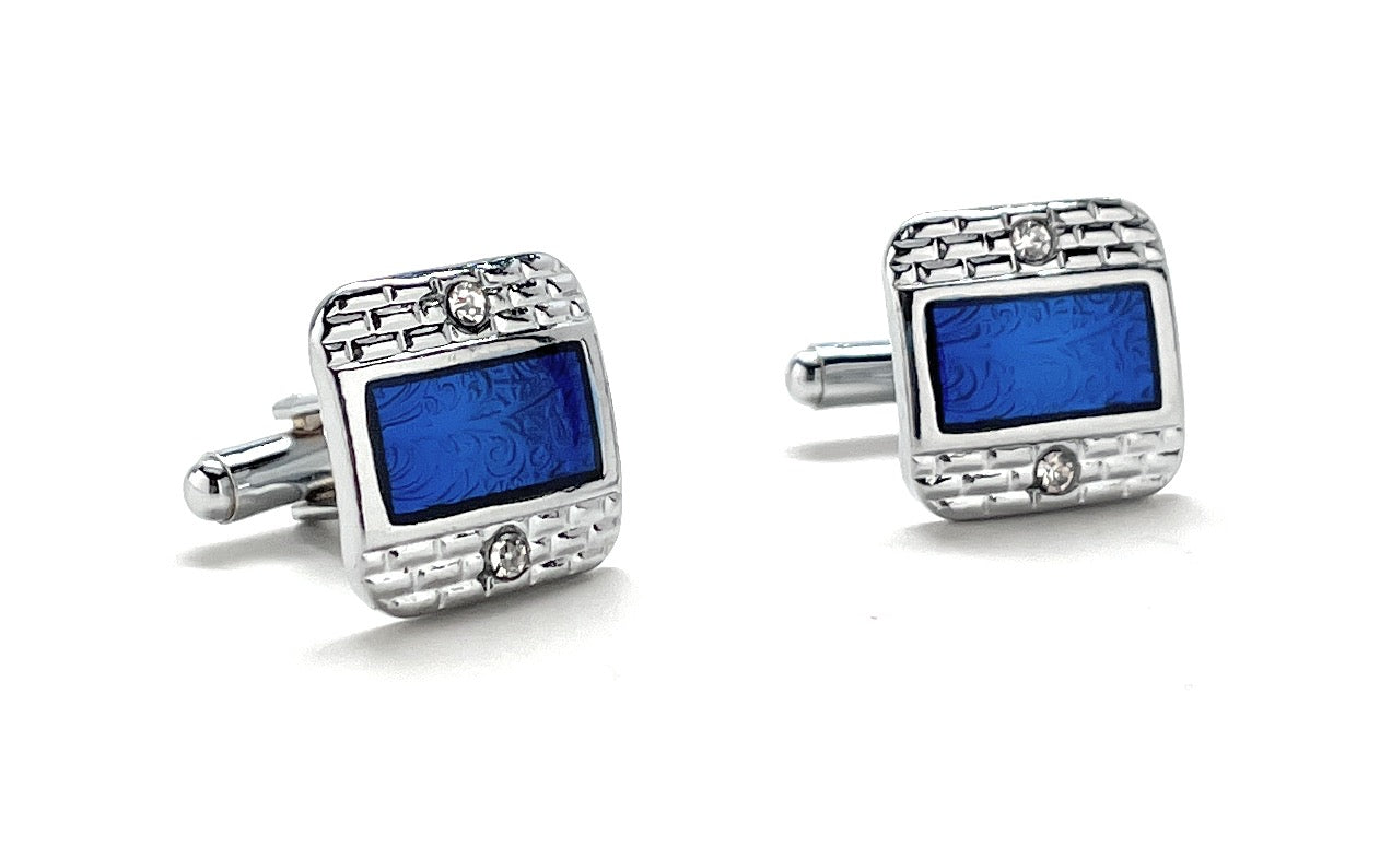 Pair of silver cufflinks with blue rectangular stones on a white background