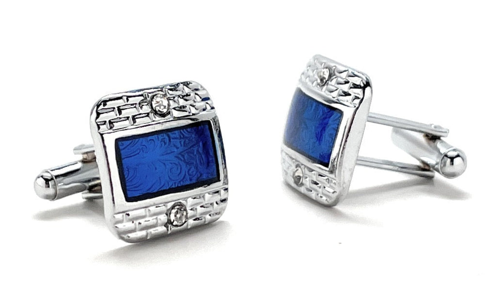 Silver cufflinks with blue gemstones on a white background