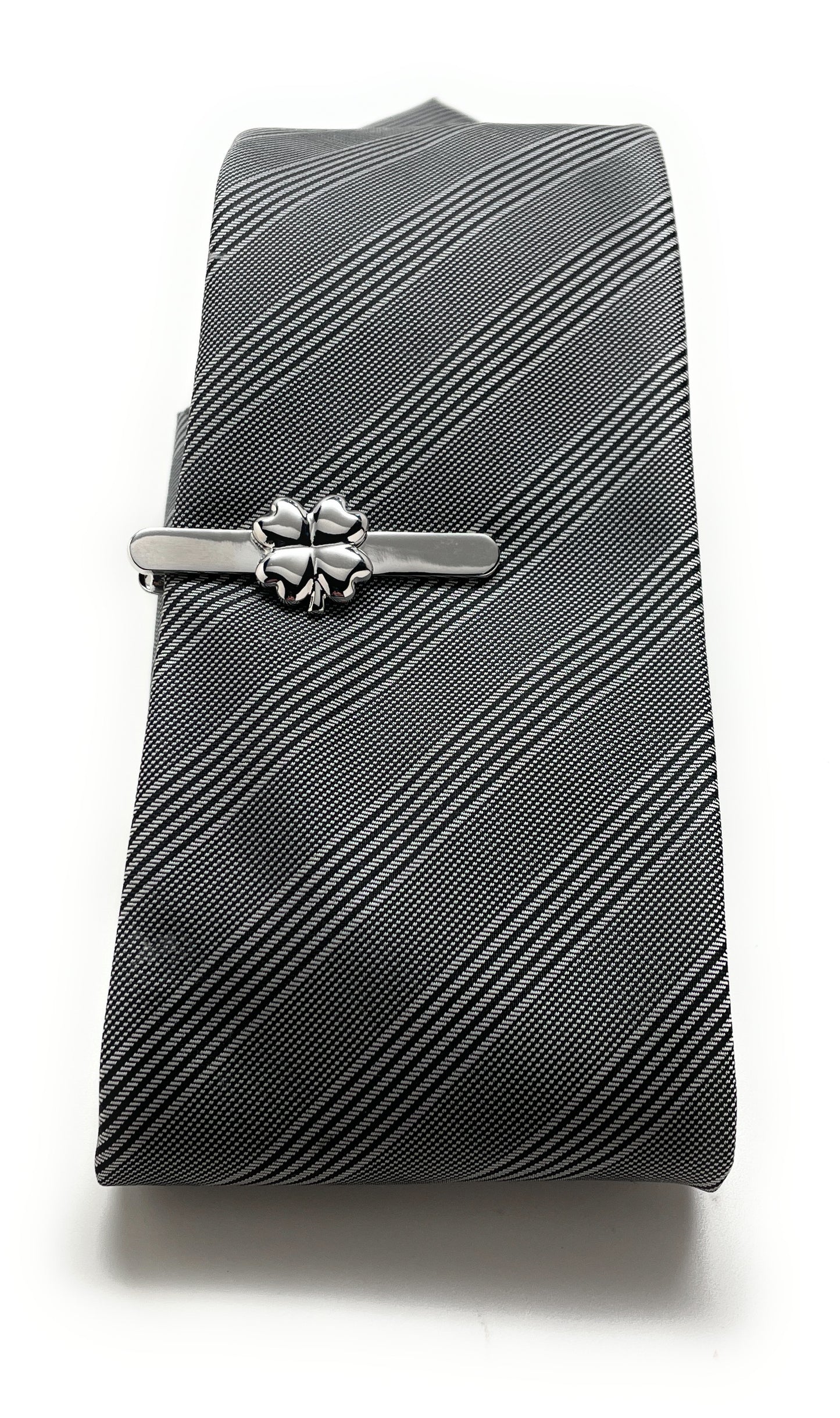 Gray striped tie with a silver tie clip on a white background